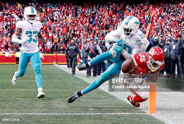 Free safety Reshad Jones of the Miami Dolphins knocks running back Charcandrick West of the Kansas City Chiefs out-of-bounds just before the endzone...