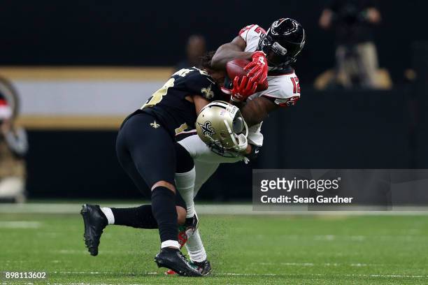 Mohamed Sanu of the Atlanta Falcons catches the ball as Marshon Lattimore of the New Orleans Saints defends during the second half of a game at the...