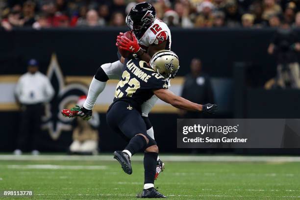 Mohamed Sanu of the Atlanta Falcons catches the ball as Marshon Lattimore of the New Orleans Saints defends during the second half of a game at the...