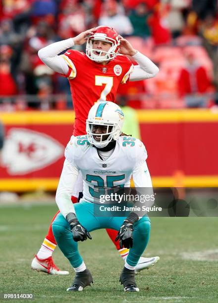 Kicker Harrison Butker of the Kansas City Chiefs and free safety Walt Aikens of the Miami Dolphins both react as they watch a long field goal go...