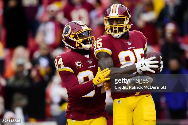 Tight end Vernon Davis of the Washington Redskins celebrates with tight end Niles Paul after scoring a touchdown against the Denver Broncos in the...
