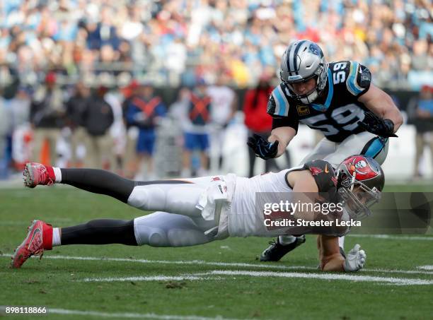 Cameron Brate of the Tampa Bay Buccaneers is tackled by Luke Kuechly of the Carolina Panthers during their game at Bank of America Stadium on...