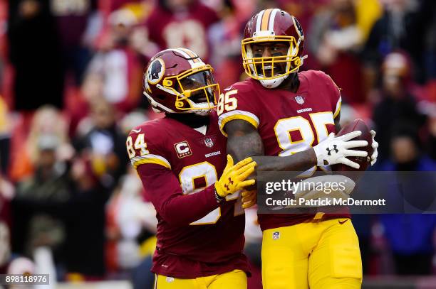 Tight end Vernon Davis of the Washington Redskins celebrates with tight end Niles Paul after scoring a touchdown against the Denver Broncos in the...