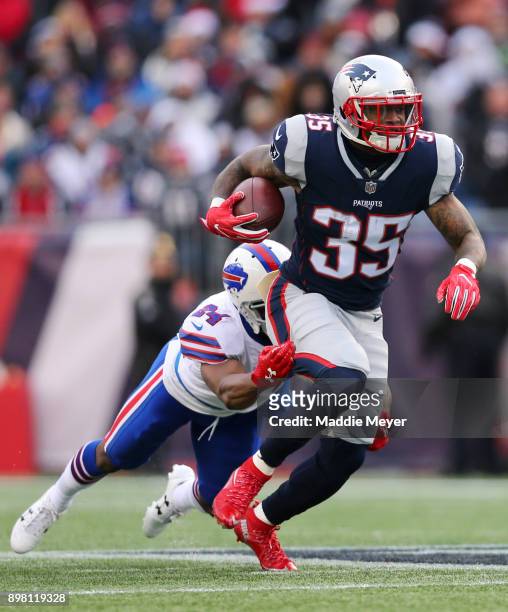 Leonard Johnson of the Buffalo Bills tackles Mike Gillislee of the New England Patriots during the second half at Gillette Stadium on December 24,...