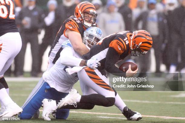 Andy Dalton of the Cincinnati Bengals is sacked by Ezekiel Ansah of the Detroit Lions during the second half at Paul Brown Stadium on December 24,...