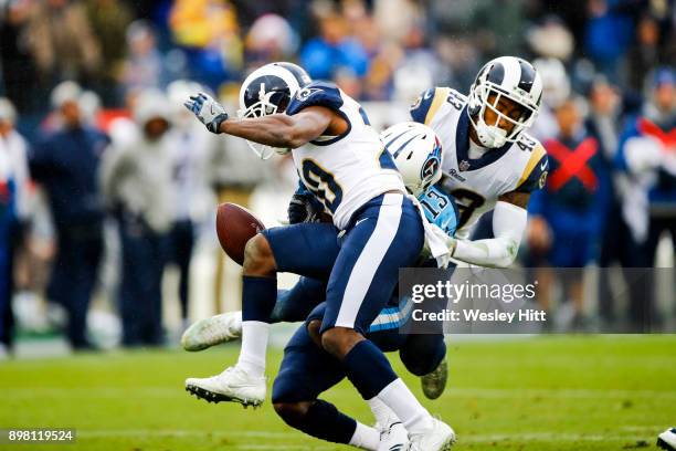 Wide Receiver Taywan Taylor of the Tennessee Titans is hit by Safety Lamarcus Joyner and Safety John Johnson III of the Los Angeles Rams at Nissan...