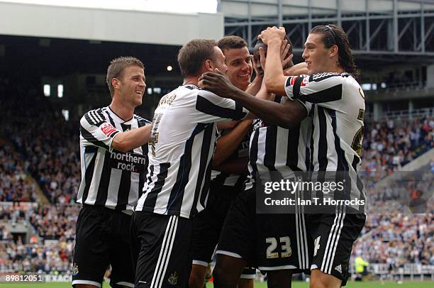 Shola Ameobi of Newcastle United is congratulated for scoring the opening goal by Steven Taylor , Andy Carroll and teammtaes during the Coca-Cola...