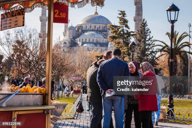 tourists travel in front of blue mosque in istanbul, turkey - corncob towers stock pictures, royalty-free photos & images