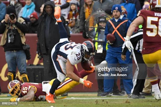 Denver Broncos running back Devontae Booker is upended in the second half as they lose to the Washington Redskins 27-11 at FedExField in Hyattsville,...
