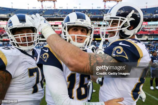 Tight End Derek Carrier, Quarterback Jared Goff and Tight End Tyler Higbee of the Los Angeles Rams celebrate following their win against the...