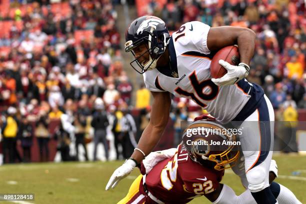 Denver Broncos wide receiver Bennie Fowler drives through a tackle by Washington Redskins strong safety Deshazor Everett in the first half as they...