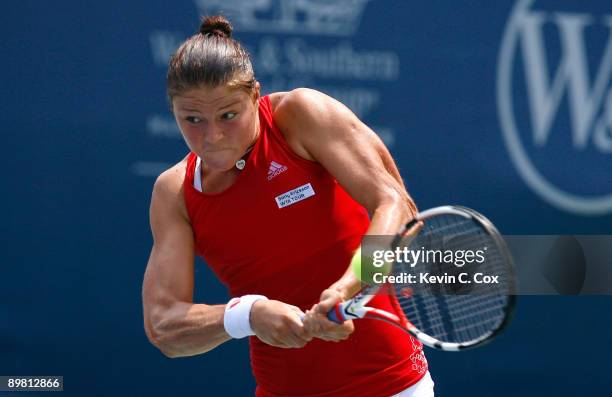 Dinara Safina of Russia returns a shot to Flavia Pennetta of Italy in the semifinals of the Western & Southern Financial Group Women's Open on August...