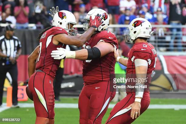 Wide receiver Larry Fitzgerald of the Arizona Cardinals celebrates a thirteen yard touchdown with offensive guard Evan Boehm and quarterback Drew...