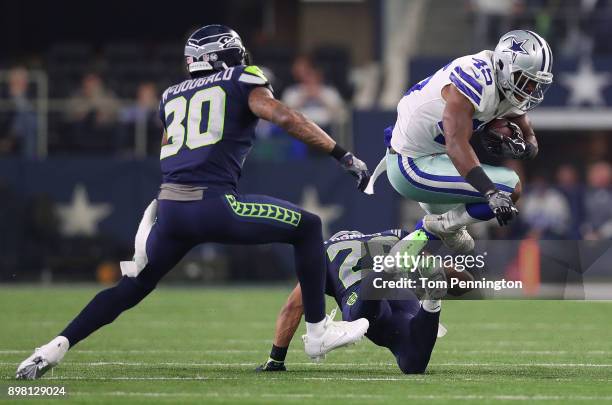 Rod Smith of the Dallas Cowboys leaps over Earl Thomas of the Seattle Seahawks on a carry in the second quarter of a football game at AT&T Stadium on...