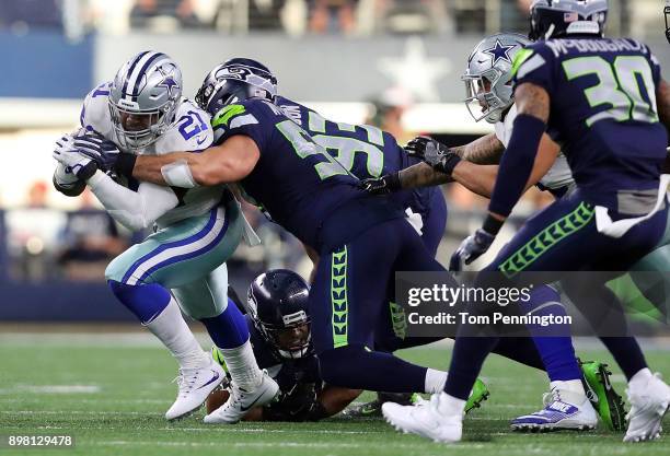 Ezekiel Elliott of the Dallas Cowboys gets hit by Michael Wilhoite of the Seattle Seahawks in the second quarter of a football game at AT&T Stadium...