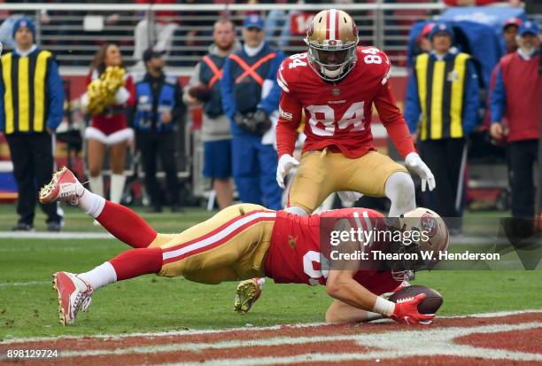 George Kittle of the San Francisco 49ers dives over the line for a 7-yard touchdown catch against the Jacksonville Jaguars during their NFL football...