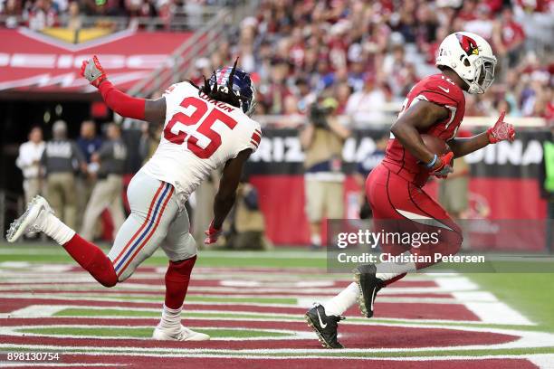 Wide receiver John Brown of the Arizona Cardinals scores a fifteen yard touchdown in front of defensive back Brandon Dixon of the New York Giants in...