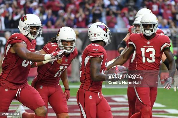 Wide receiver John Brown of the Arizona Cardinals is congratulated by teammates after scoring a fifteen yard touchdown against the New York Giants in...