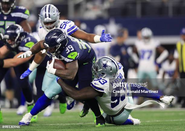 Datone Jones of the Dallas Cowboys and Benson Mayowa of the Dallas Cowboys stop the run by Mike Davis of the Seattle Seahawks in the second quarter...