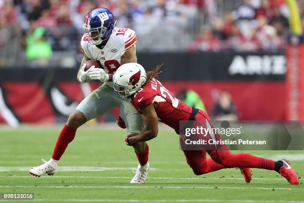 Wide receiver Roger Lewis of the New York Giants makes a reception against defensive back Tramon Williams of the Arizona Cardinals in the first half...