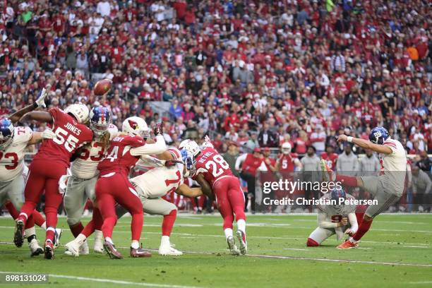 Kicker Aldrick Rosas of the New York Giants unsuccessfully kicks a field goal against the Arizona Cardinals in the first half at University of...