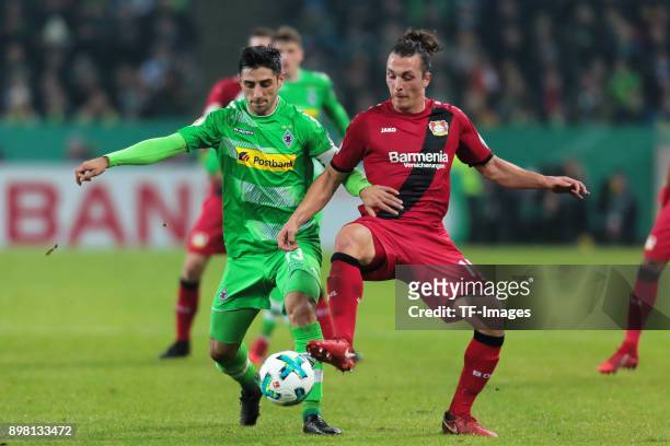 Lars Stindl of Moenchengladbach and Julian Baumgartlinger of Leverkusen battle for the ball during the DFB Cup match between Borussia...