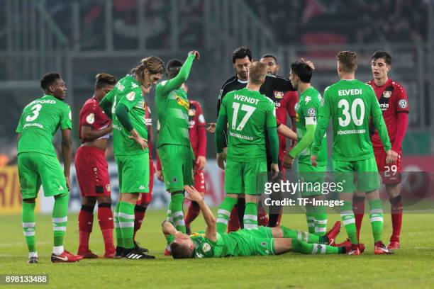 Referee Manuel Graefe speaks with players of Moenchengladbach during the DFB Cup match between Borussia Moenchengladbach and Bayer Leverkusen at...