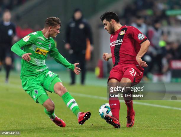 Kevin Volland of Leverkusen and Mickael Cuisance of Moenchengladbach battle for the ball during the DFB Cup match between Borussia Moenchengladbach...