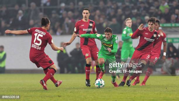 Mickael Cuisance of Moenchengladbach, Dominik Kohr of Leverkusen and Panagiotis Retsos of Leverkusen battle for the ball during the DFB Cup match...