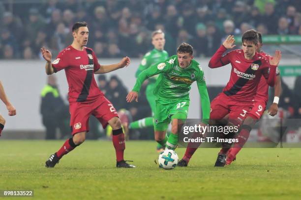 Mickael Cuisance of Moenchengladbach and Dominik Kohr of Leverkusen battle for the ball during the DFB Cup match between Borussia Moenchengladbach...