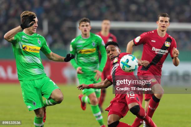 Patrick Herrmann of Moenchengladbach and Wendell of Leverkusen battle for the ball during the DFB Cup match between Borussia Moenchengladbach and...