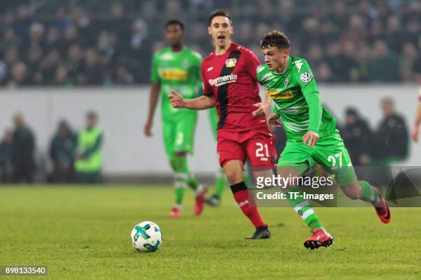 Mickael Cuisance of Moenchengladbach and Dominik Kohr of Leverkusen battle for the ball during the DFB Cup match between Borussia Moenchengladbach...