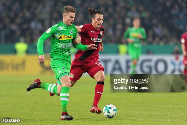 Nico Elvedi of Moenchengladbach and Kevin Volland of Leverkusen battle for the ball during the DFB Cup match between Borussia Moenchengladbach and...
