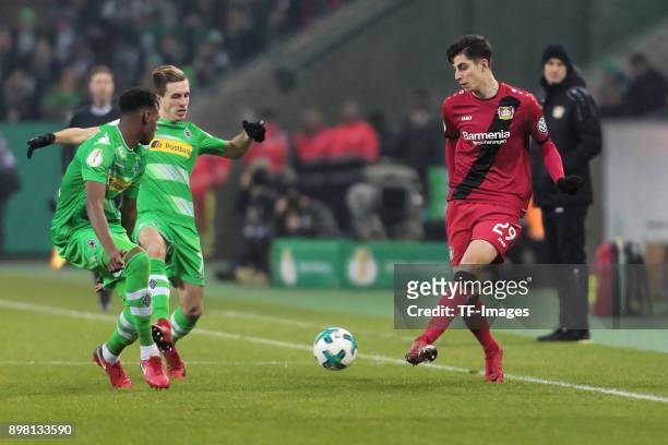 Kai Havertz of Leverkusen and Patrick Herrmann of Moenchengladbach battle for the ball during the DFB Cup match between Borussia Moenchengladbach and...