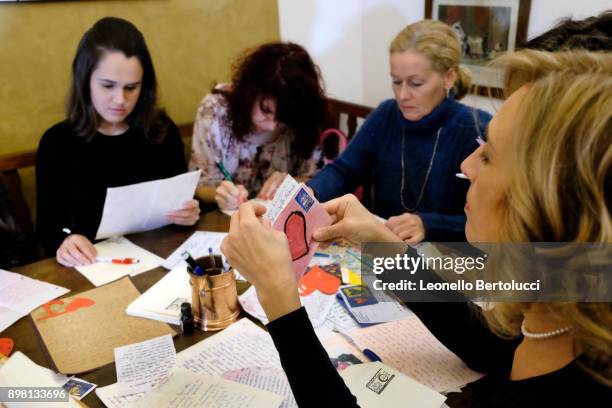 The Juliet Club's team of volunteers responsible for replying to letters received from all over the world pose in Via Cappello 23, which is today...