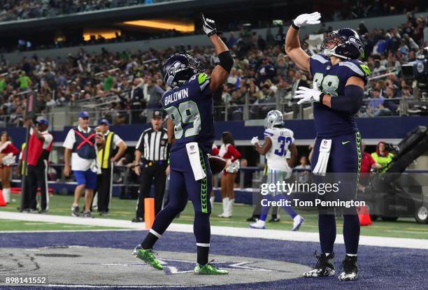 Doug Baldwin of the Seattle Seahawks celebrates a fourth quarter touchow with Jimmy Graham of the Seattle Seahawks against the Dallas Cowboys at AT&T...