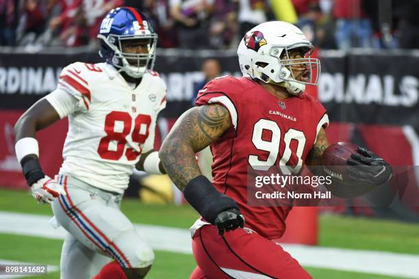 Defensive tackle Robert Nkemdiche of the Arizona Cardinals runs in a 21 yard fumble recovery touchdown in front of tight end Jerell Adams of the New...