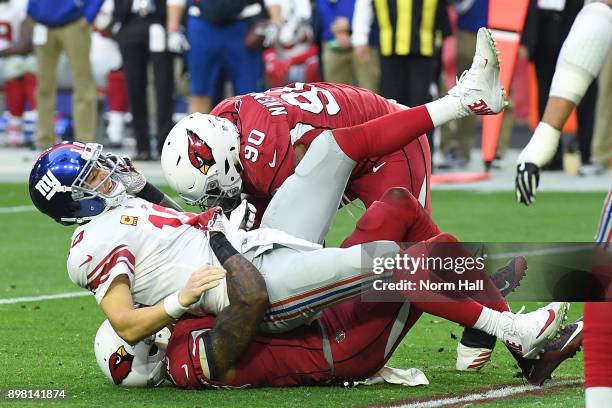 Quarterback Eli Manning of the New York Giants is sacked by inside linebacker Deone Bucannon of the Arizona Cardinals in the second half at...