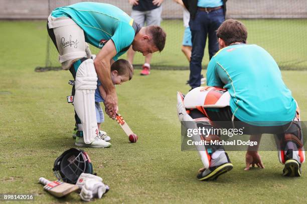 Shaun Marsh hits the ball with son Austin with brother Mitch Marsh who bowls it to them during the Australian nets session at the on December 25,...