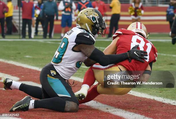 Trent Taylor of the San Francisco 49ers catches a touchdown pass in front of Tashaun Gipson of the Jacksonville Jaguars during their NFL football...