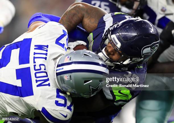 Mike Davis of the Seattle Seahawks is tackled by Damien Wilson of the Dallas Cowboys in the second half at AT&T Stadium on December 24, 2017 in...