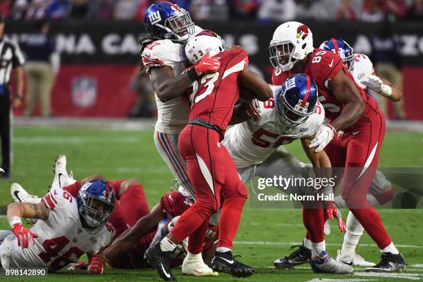 Running back Kerwynn Williams of the Arizona Cardinals is stopped by linebacker Kelvin Sheppard of the New York Giants in the second half at...