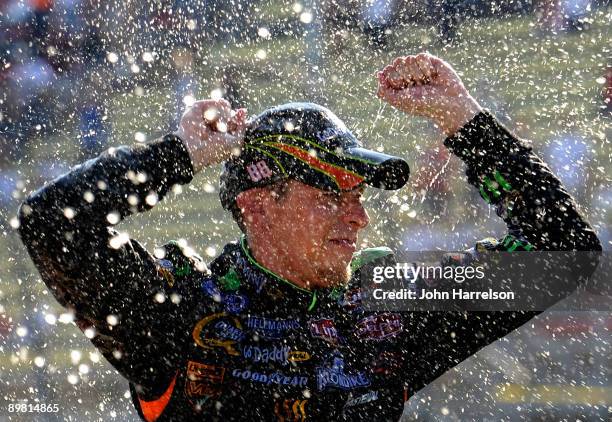 Brad Keselowski, driver of the GoDaddy.com Chevrolet celebrates after winning the NASCAR Nationwide Series at Michigan International Speedway on...