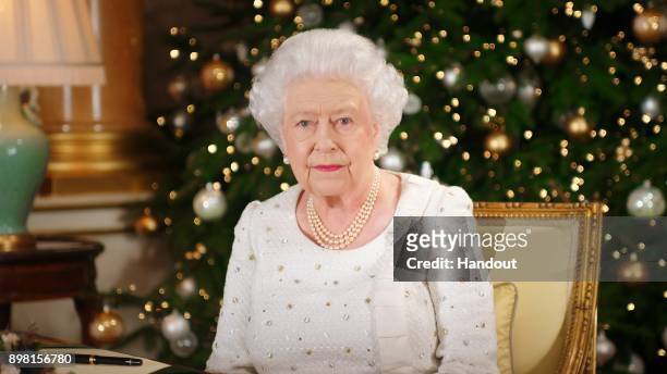 In this undated image supplied by Sky News, Queen Elizabeth II sits at a desk in the 1844 Room at Buckingham Palace, as she records her Christmas Day...