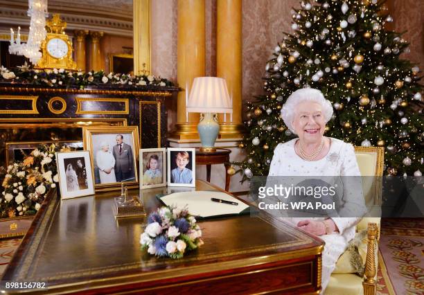 In this undated image supplied by Sky News, Queen Elizabeth II sits at a desk in the 1844 Room at Buckingham Palace, after recording her Christmas...