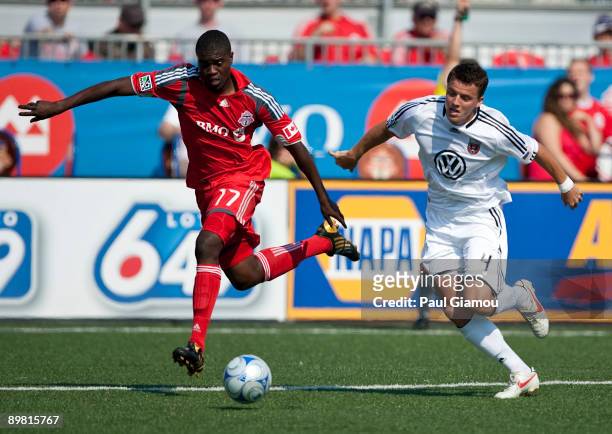 Forward O'Brian White of the Toronto FC chases the ball with defender Marc Burch of D.C. United at BMO Field on August 15, 2009 in Toronto, Canada.