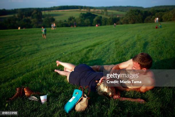 Shane Gray and Bonnie Ba relax during the concert marking the 40th anniversary of the Woodstock music festival August 15, 2009 in Bethel, New York....