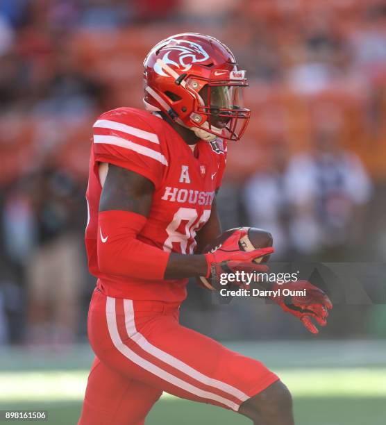 Steven Dunbar of the Houston Cougars speeds past the defense and hauls in a pass during the first quarter of the Hawaii Bowl against the Fresno State...