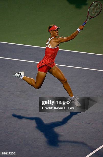Elena Dementieva of Russia returns a shot to Jelena Jankovic of Serbia during the semifinals of the Western & Southern Financial Group Women's Open...