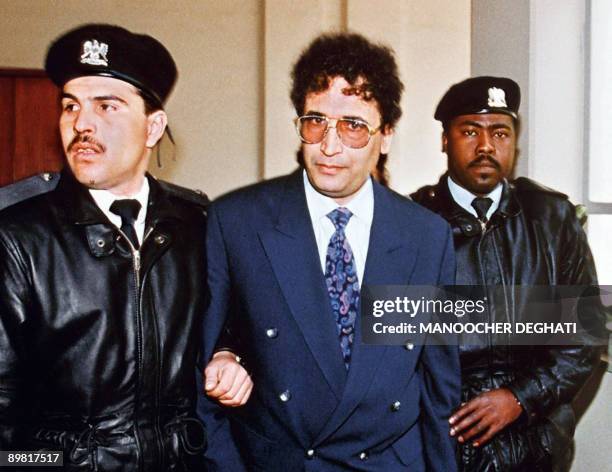 File photo taken February 18, 1992 in Tripoli shows convicted Lockerbie bomber Abdelbaset Ali Mohmet al-Megrahi being escorted by security officers....